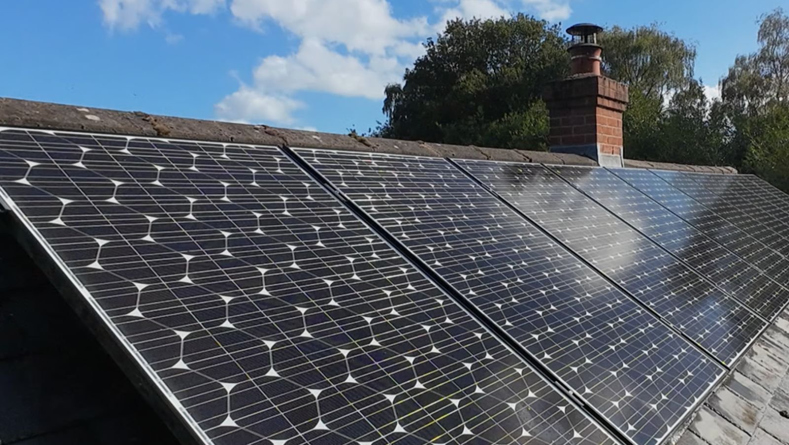 The same solar panels after cleaning: clear dark glass with crisp white cell lines