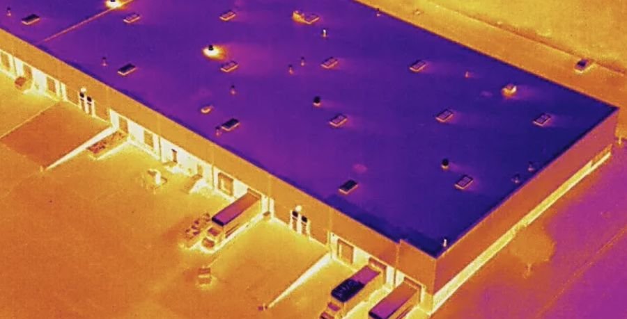 Thermal drone image of a large commercial building roof and loading bays